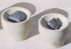 Magnesia cupels loaded with sample wrapped in lead foil